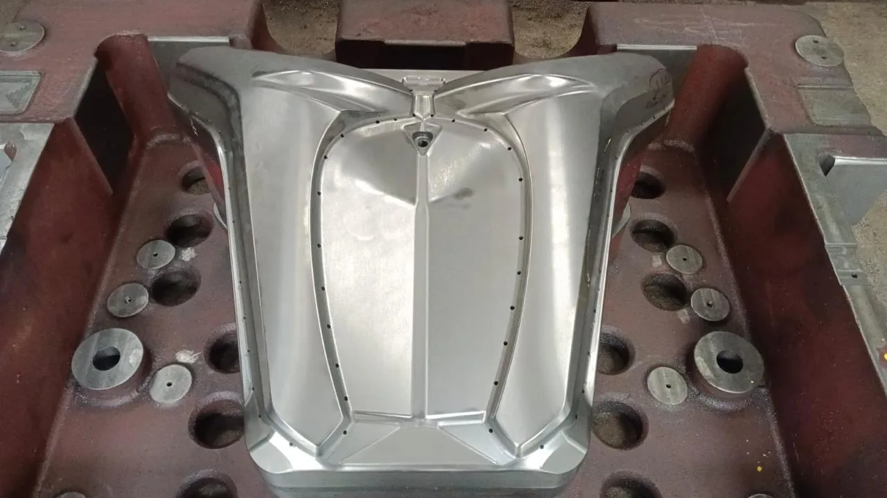 A deep drawn die cavity machined and polished to a mirror finish