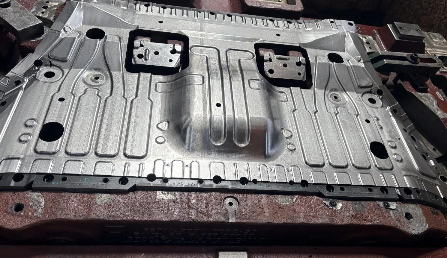Large sheet metal press tool with machined channels and black insert blocks