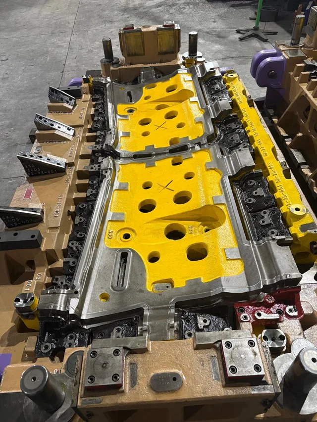 A multi station press tool with a yellow die face, machined at Om Sai Tools and Technologies